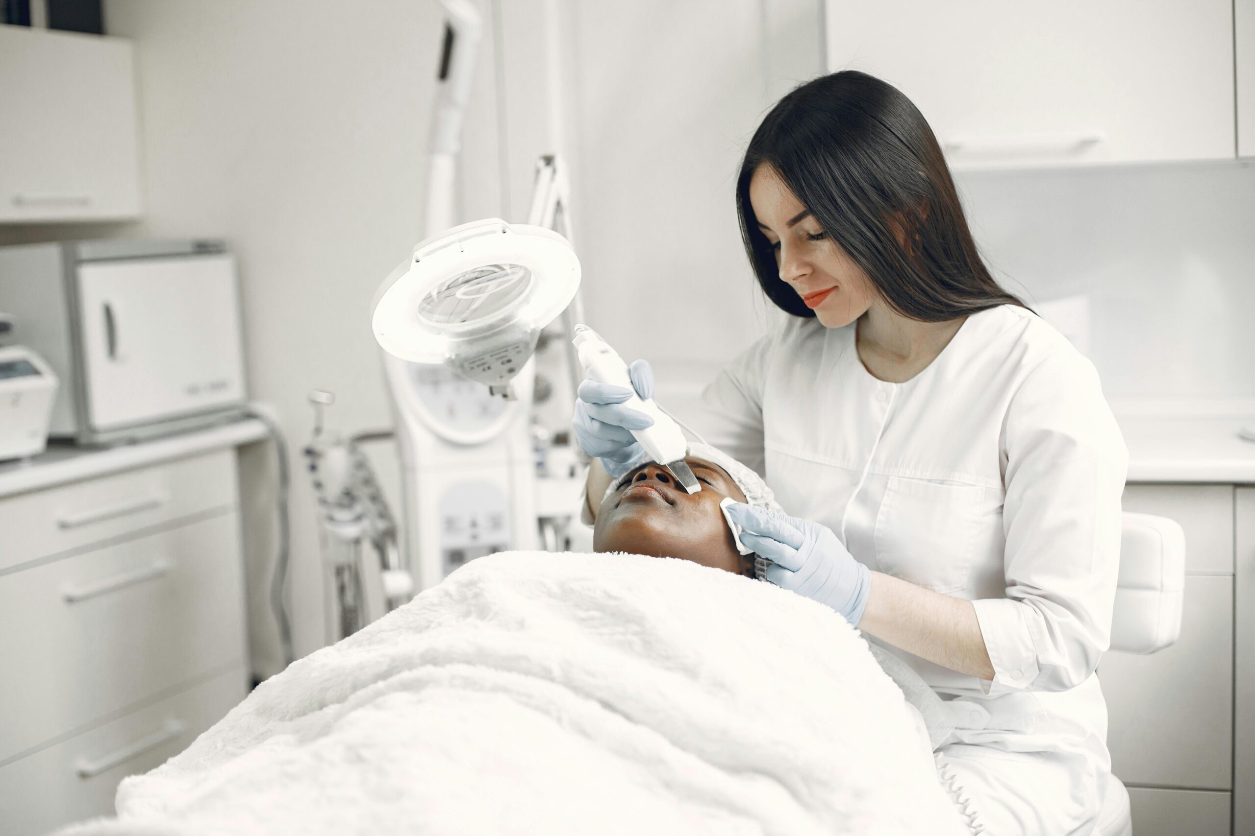 A skilled practitioner performs a relaxing facial treatment, promoting wellness and skincare in a modern clinic.